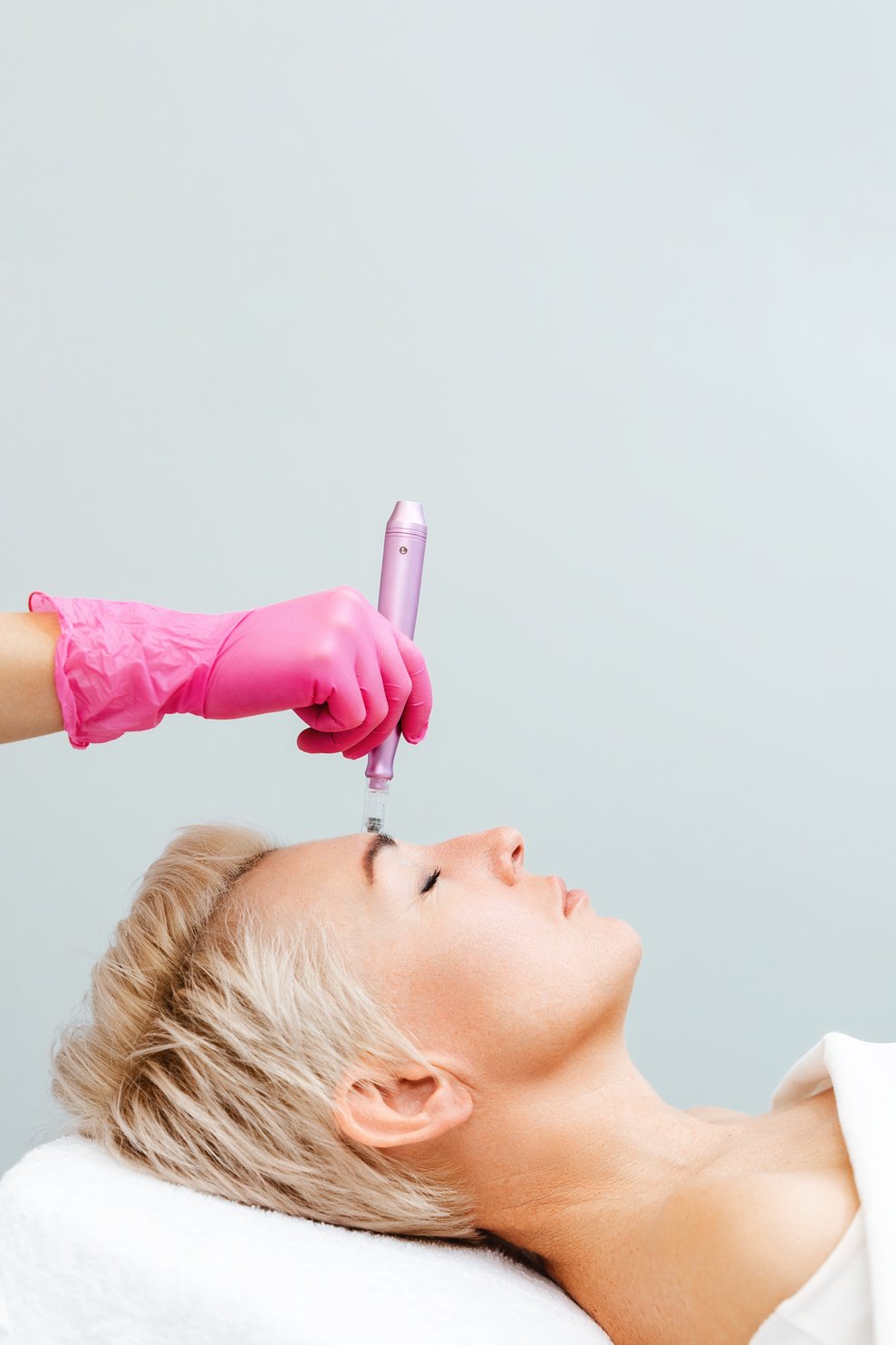 Anti-Aging Treatment and Face Lift. Adult Woman at a Mesotherapy Session in a Professional Clinic of Aesthetic Medicine. Vertical. Copy Space